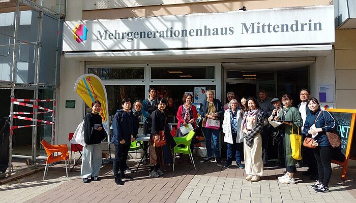 Die japanische Delegation steht vor dem Mehrgenerationenhaus