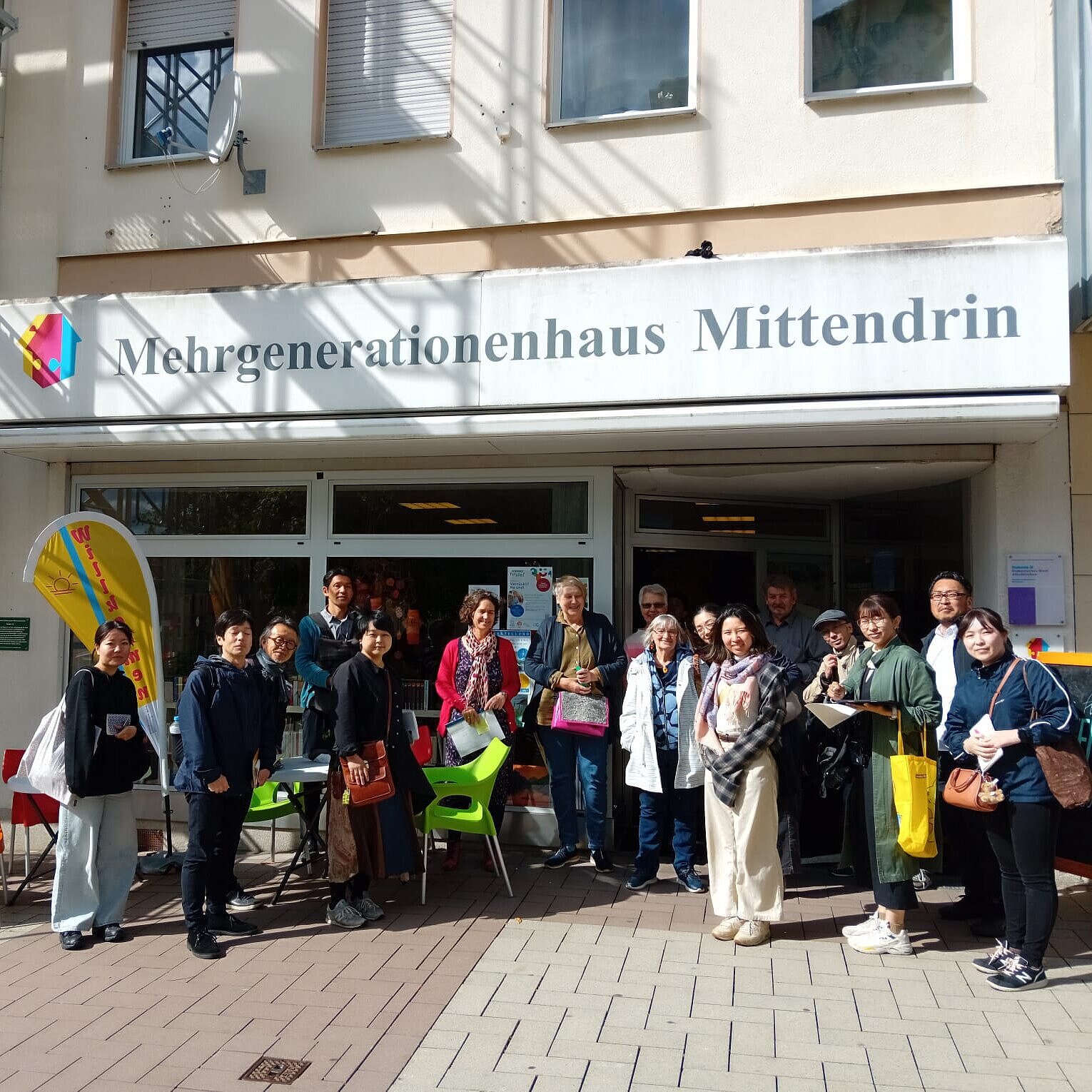 Die japanische Delegation steht vor dem Mehrgenerationenhaus